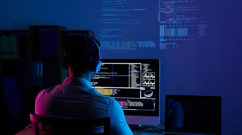 a man coding on his computer showing essential skills for web development careers