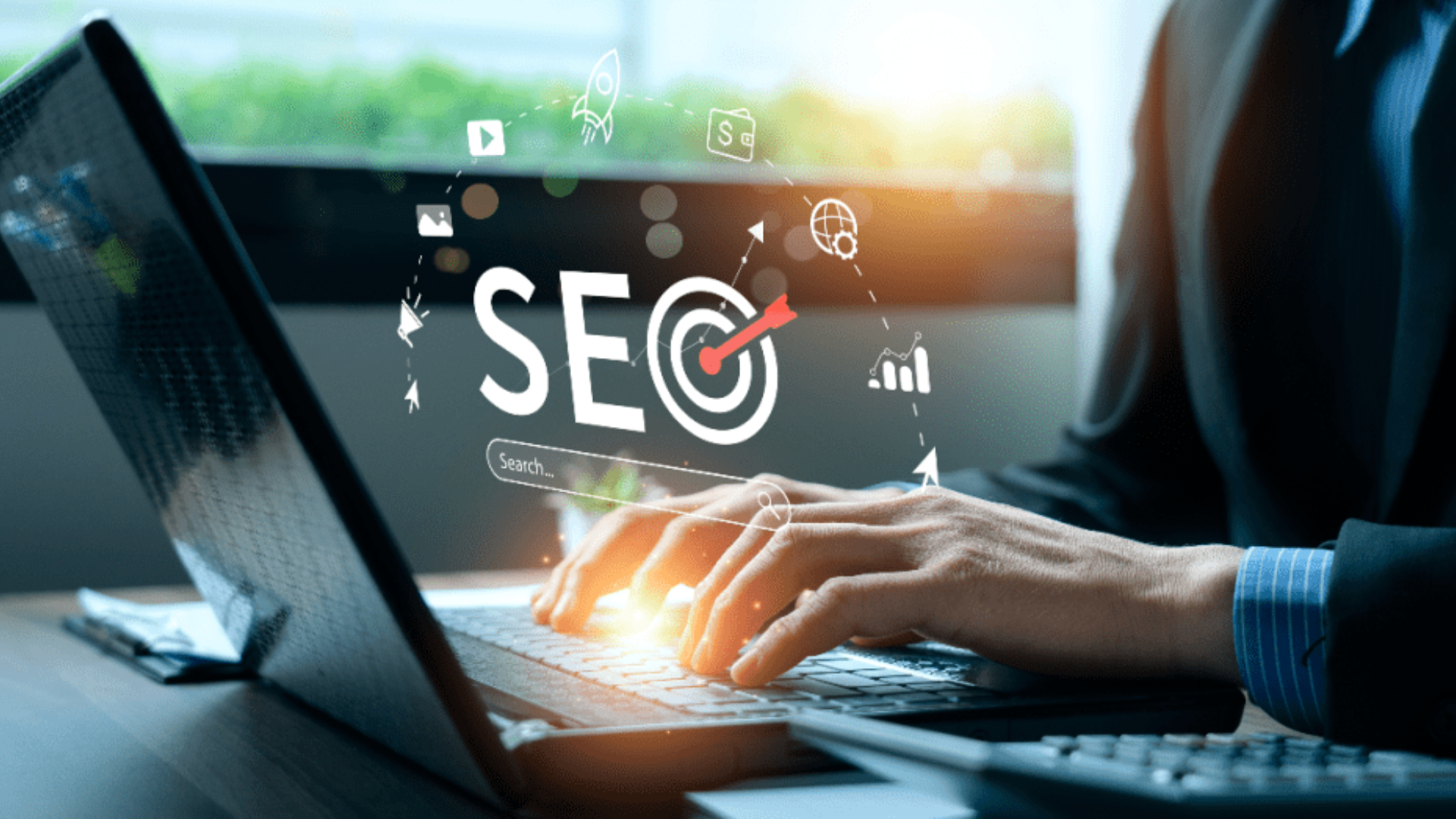Person using laptop with SEO icons on screen